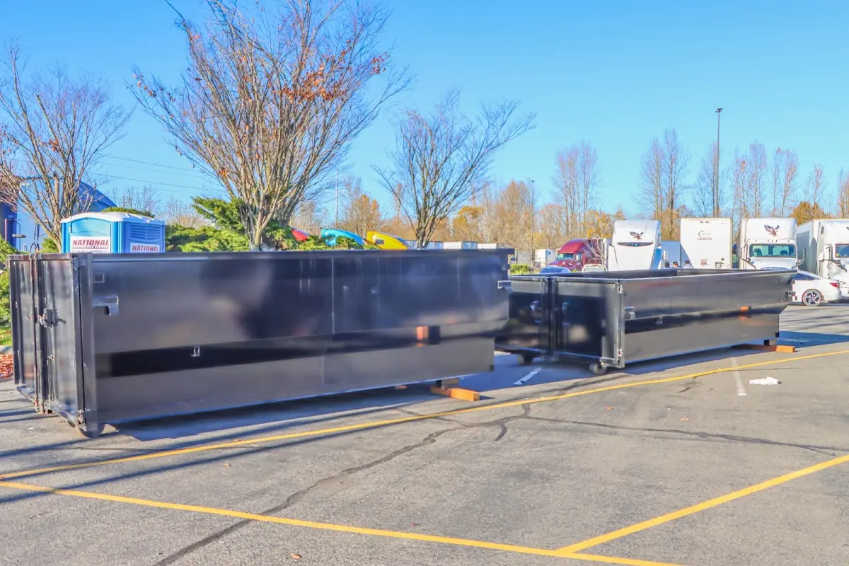 Professional dumpster rental service with roll-off container on residential driveway in Bristol